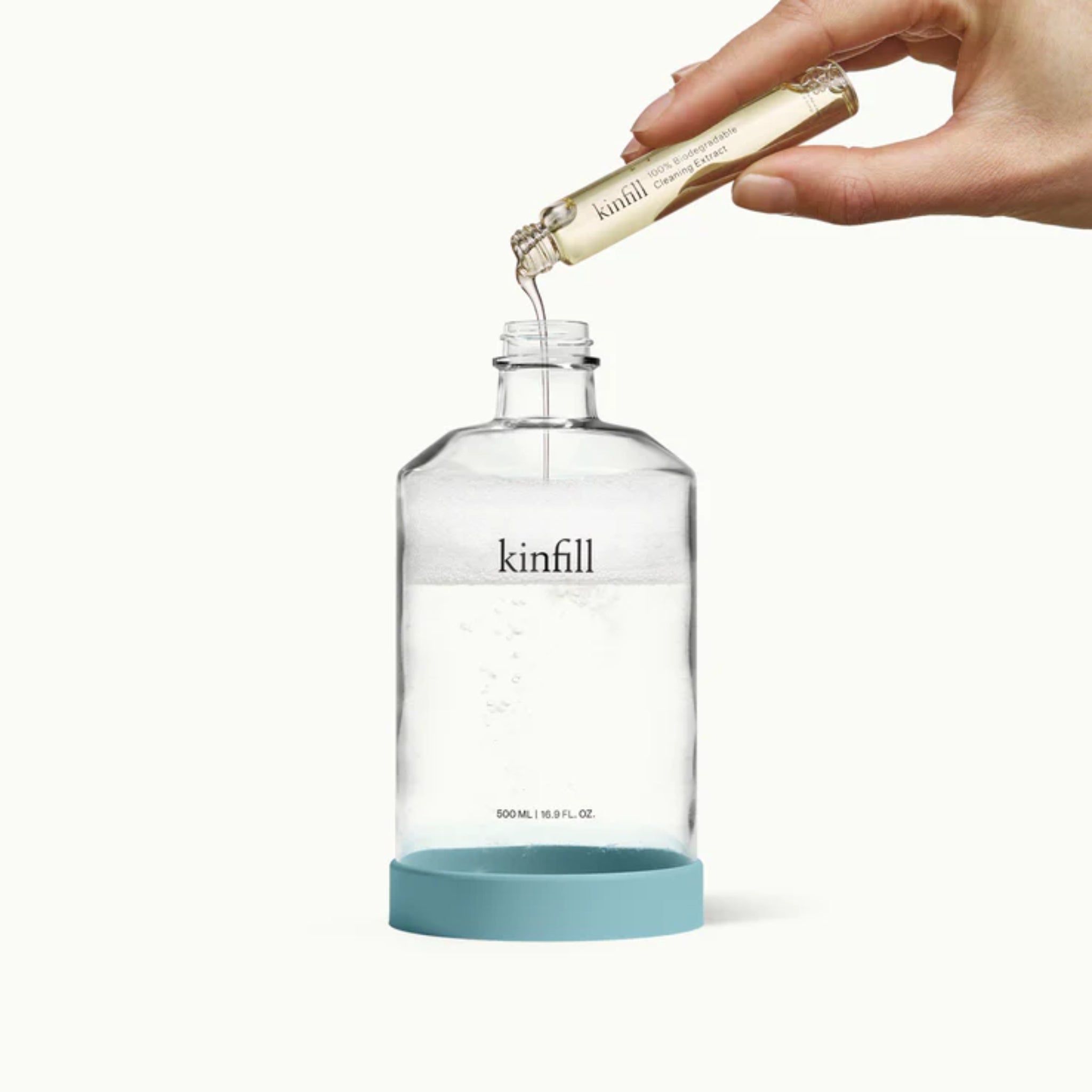Kinfill Kitchen Cleaner Kit Pine Husk refill pouch alongside glass spray bottle, eco-conscious design.