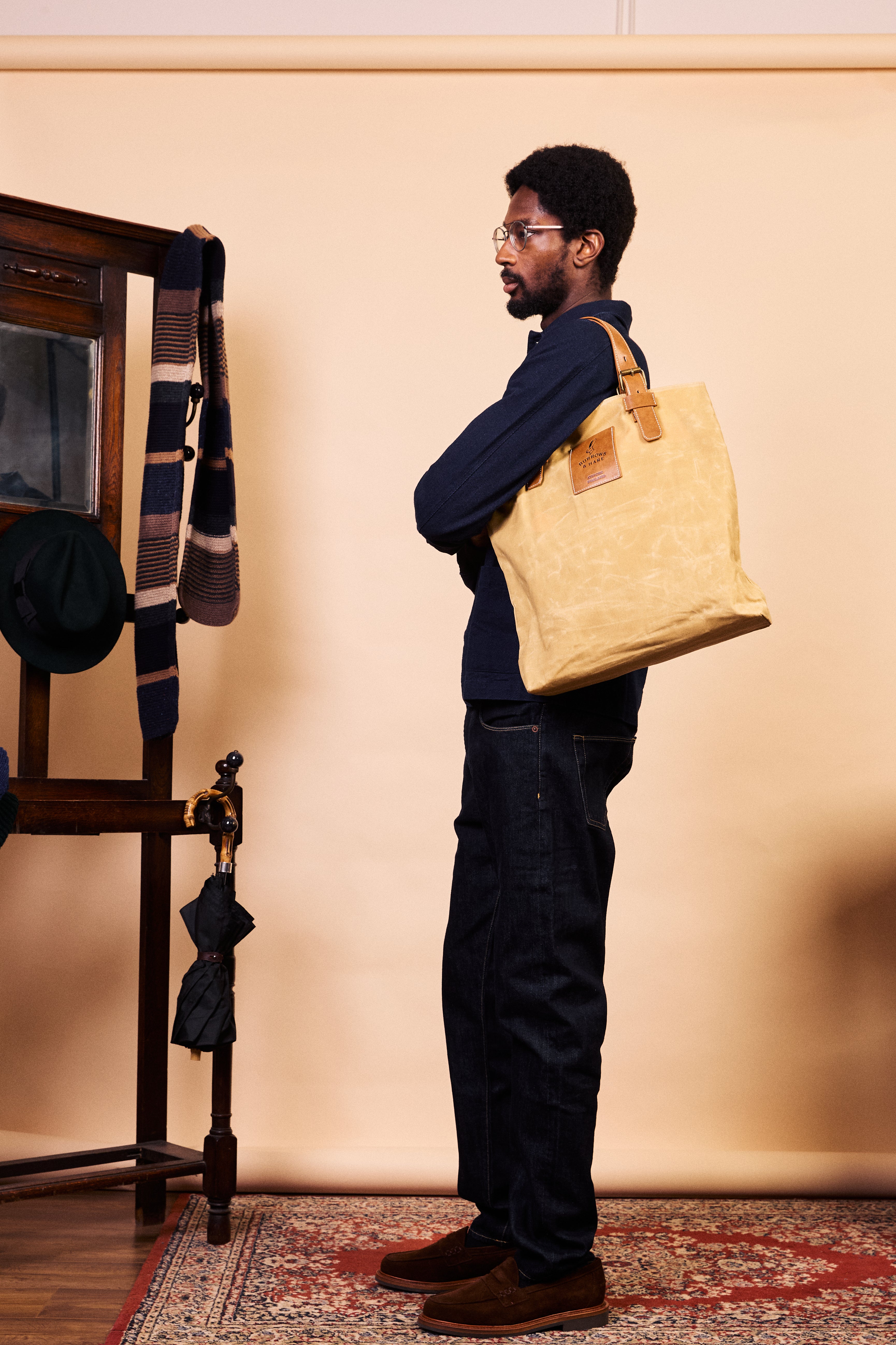Burrows & Hare natural waxed canvas tote held in hand