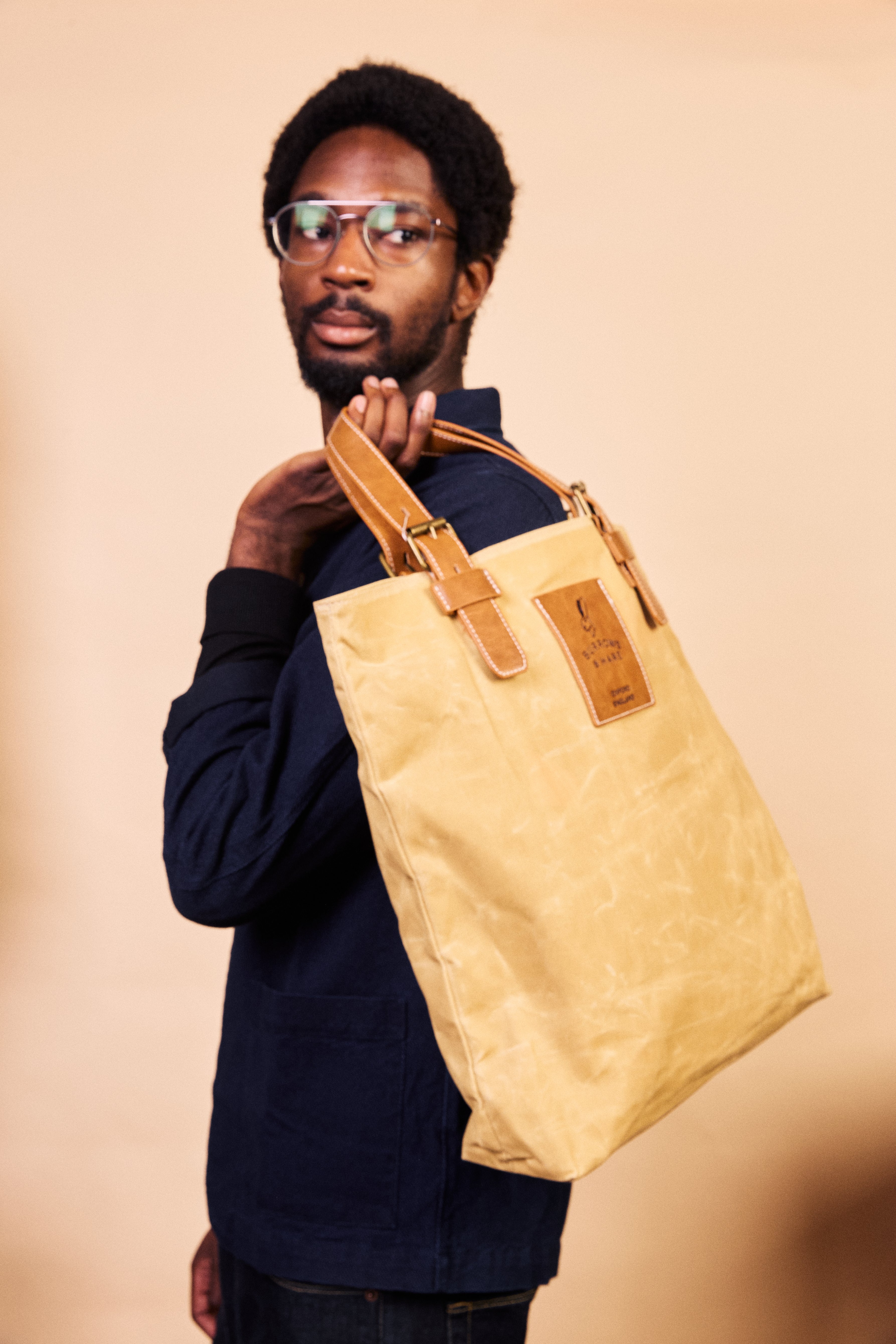 Interior of the natural waxed canvas tote showing the zip compartment and patch pockets
