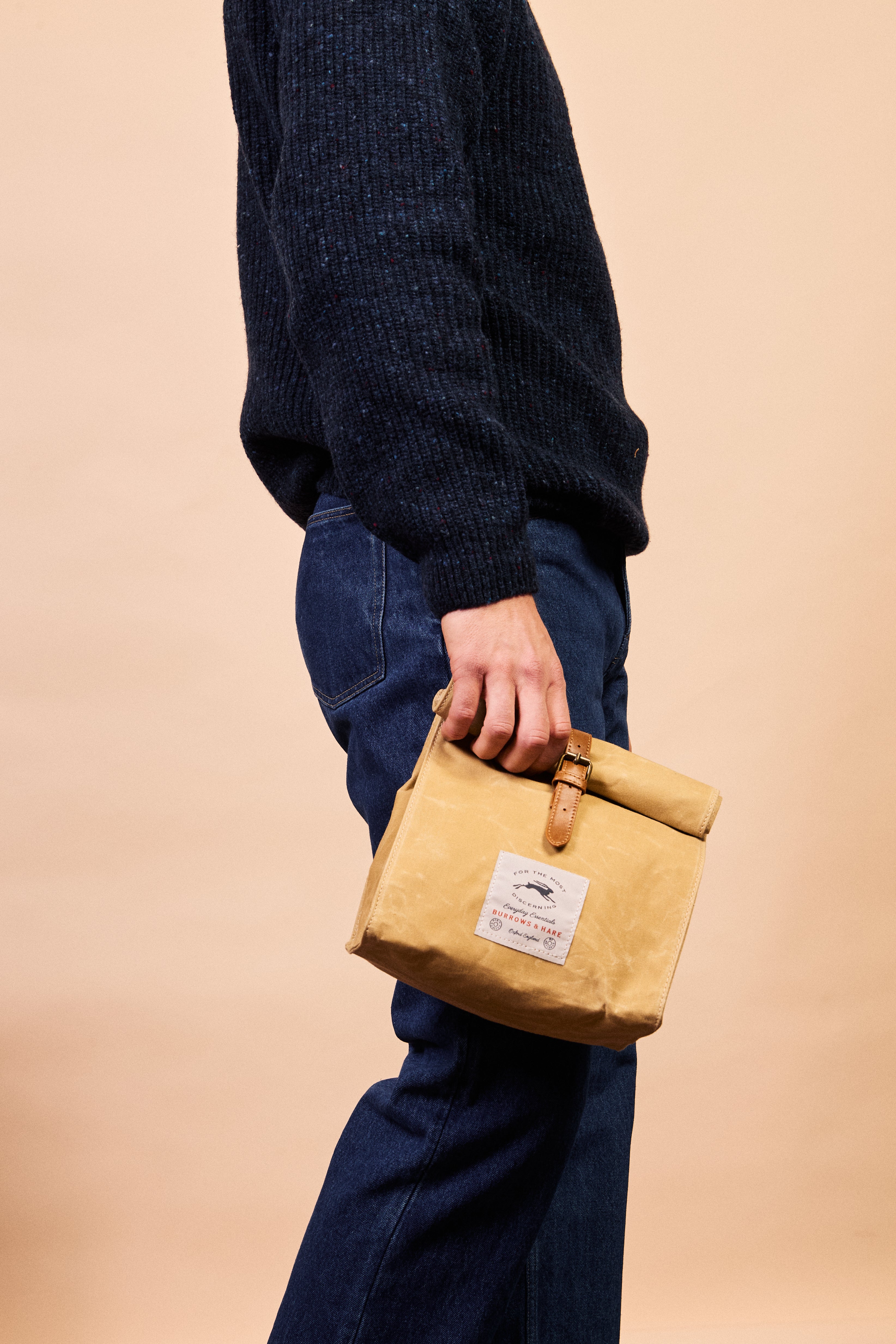 Close-up of the leather strap and accents on the thermal lunch bag