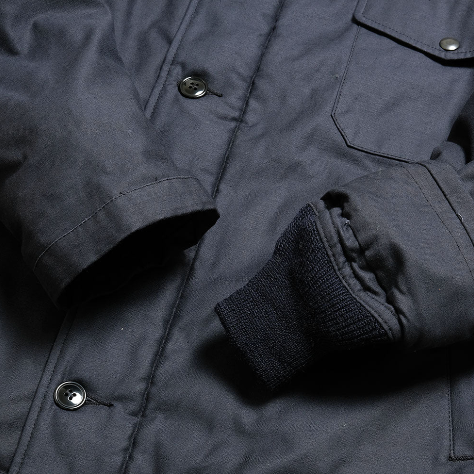 Detail view of A-2 Deck Jacket "Civilian Model" showcasing rib-knit collar, navy cotton.