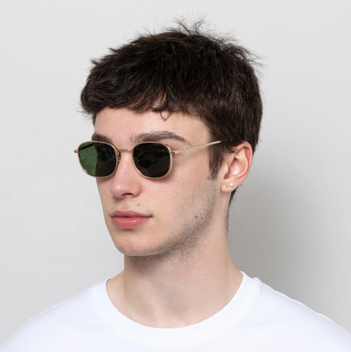 Angled view of Hello - Gold sunglasses by A. Kjærbede with Tritan and polycarbonate.